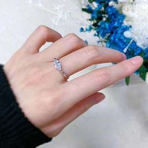 Close-up of a marquise-cut marquise diamond ring in 925 silver worn on a finger