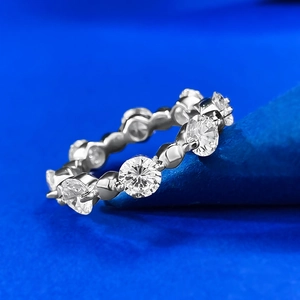 Elegant S925 silver eternity ring with pavé-set round cubic zirconia on blue background