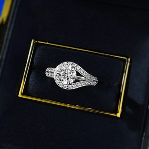 Macro detail of 1-carat round brilliant cut diamond ring in silver halo setting