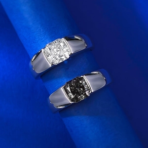 Macro shot of silver ring with square-cut carbon diamond in a modern bezel setting