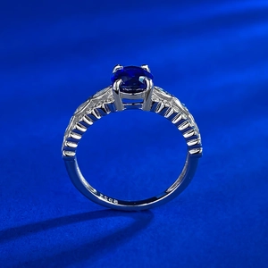 Detailed view of S925 sterling silver ring with oval blue gemstone and side diamonds
