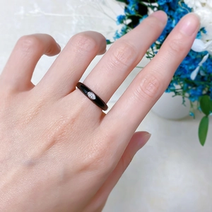 Close-up of minimalist black enamel thin band ring with marquise-cut marquise zircon