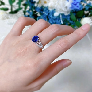 Detailed view of an S925 silver ring featuring an oval blue gem and micro-paved diamonds