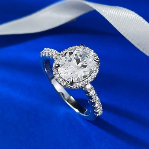 Classic S925 sterling silver halo ring with oval white stone on blue silk background
