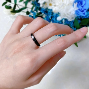 Detail of S925 silver ring with black enamel band and a sparkling marquise zircon stone