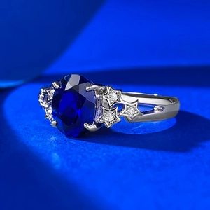 S925 sterling silver ring with blue oval gemstone and side star accents in silver finish