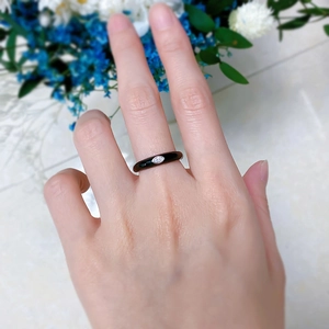 Detailed view of S925 silver ring with black enamel and marquise-cut crystal on finger