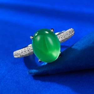 Macro view of green chalcedony gemstone ring with micro-paved silver band and four-prong setting