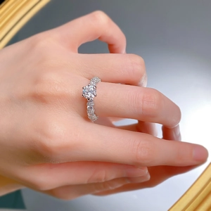 Close-up of S925 silver ring with 1 carat round solitaire and pavé diamond band