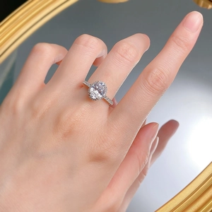 Macro detail of oval cut halo diamond ring with pave setting on silver band