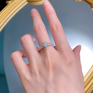 Macro close-up of a 1-carat round brilliant-cut Moissanite ring on a woman's finger