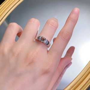 Macro view of S925 silver ring with square-cut champagne diamond on hand mirror