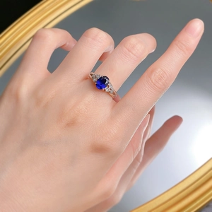 Detailed shot of an S925 silver ring featuring a blue oval gem and small star accents