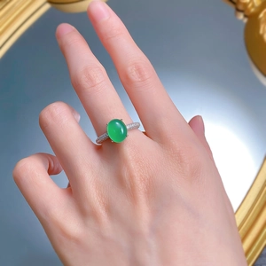 Macro shot of 925 silver ring featuring oval green chalcedony and pave-set micro diamonds