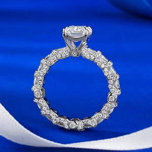 Classic S925 sterling silver ring with emerald cut diamond on blue silk background