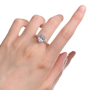 Classic S925 sterling silver oval ring with halo diamonds shown on model hand
