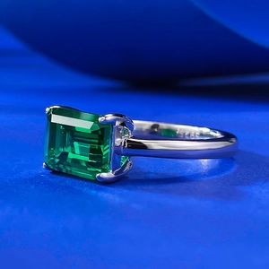 Macro shot of S925 sterling silver emerald cut green gemstone ring with four-prong setting