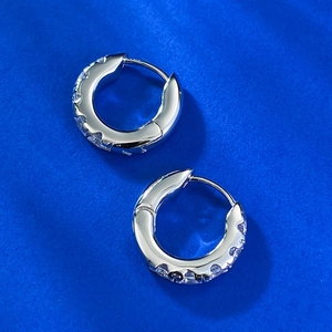 Detailed close-up of S925 sterling silver hoop earrings with shimmering white cubic zirconia