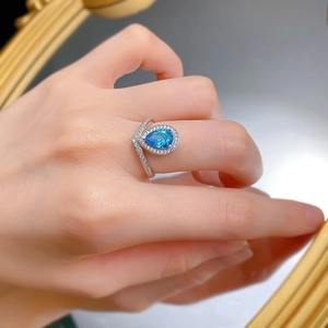 Detailed view of S925 silver crown ring with pear-cut aquamarine and pavé-set zircons