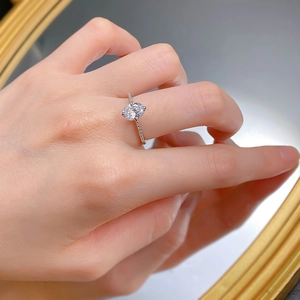 Macro shot of a 925 silver ring featuring an oval-cut main stone and micro-pave diamonds