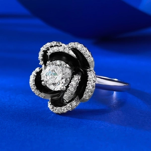 Detail view of S925 silver camellia ring with black enamel petals and a zircon center