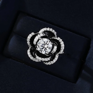 Macro shot of S925 silver camellia ring featuring a black petal design with a white diamond center