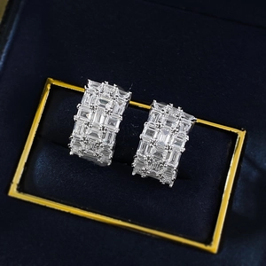 Macro shot of silver rectangular hoop earrings with full-pavé radiant cut zircon stones