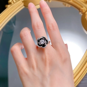 Detailed view of S925 silver camellia ring with black enamel and sparkling round diamond