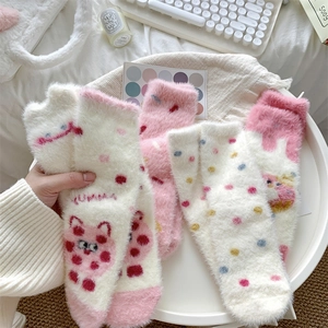 Detail of plush thermal coral fleece socks with cat patterns and YUMMY print