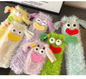 Close-up of fuzzy funny character socks with vibrant plush textures and goofy 3D eyes