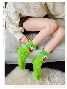 Detail showing plush green coral velvet socks with funny cartoon eyes and red lips
