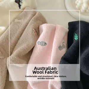 Detail of warm plush socks with cute cat embroidery and soft thermal fabric texture