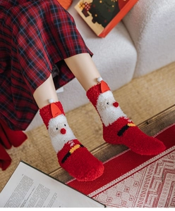 Detail of plush coral fleece Christmas socks featuring Santa Claus design and 3D hat detail