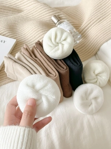 Detailed texture of thick thermal terry socks in various neutral earthy colors