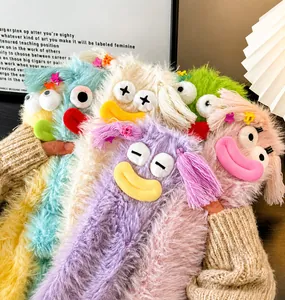 Close-up of colorful fuzzy socks with cartoon eyes and soft coral fleece texture