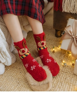 Detailed view of red Christmas coral fleece socks with 3D reindeer ears and snowflake patterns
