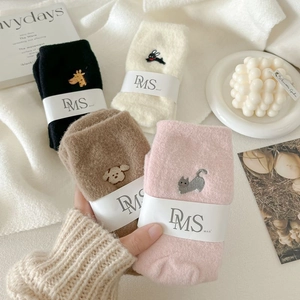 Detail of four-color thick plush thermal socks with cute animal embroidery and soft texture