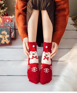 Detail of Christmas coral fleece socks featuring a 3D white bear and snowflake patterns
