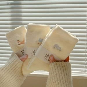 Detailed view of soft cream chenille socks with fox, bird, and rabbit animal embroidery
