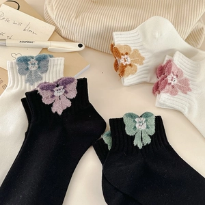 Women's crew socks with 3D plush bows in macaron colors and cozy knit texture