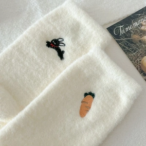 Detailed view of plush thermal socks with cute bunny and carrot embroidery details