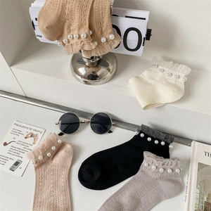 Detail of sweet ruffle cuffs with pearl accents on Japanese style mesh ankle socks