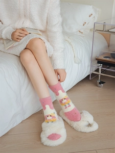 Cozy pink coral fleece socks with cartoon patterns paired with white plush slippers