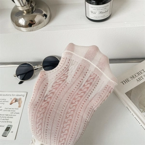 Close-up of cream lace socks featuring delicate hollow patterns and breathable mesh texture