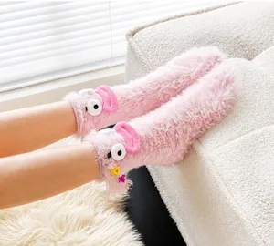 Detailed view of pink fuzzy socks with cute cartoon eyes and colorful star charms