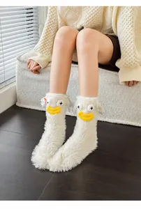 Detail of plush fuzzy socks with cute duck character design and soft white faux fur texture