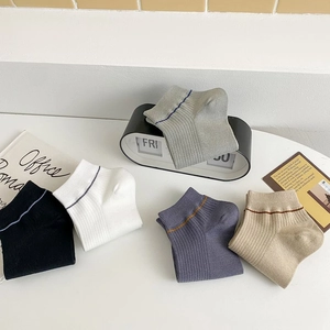 Detailed flat lay of cotton crew socks in five colors with sporty striped cuff detail