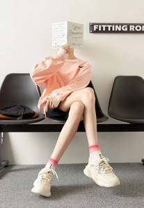 Detail of breathable cotton ankle socks with pink rainbow stripes in a sporty street style