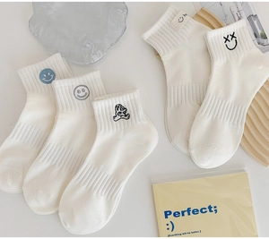 Detailed set of 5 white cotton socks featuring cute embroidered smileys and bear patterns
