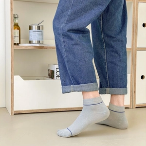 Detail of light gray ribbed cotton low-cut men's socks with thin navy blue stripes